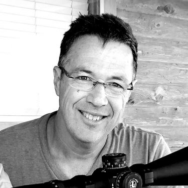 Black-and-white photo of a man with a gun